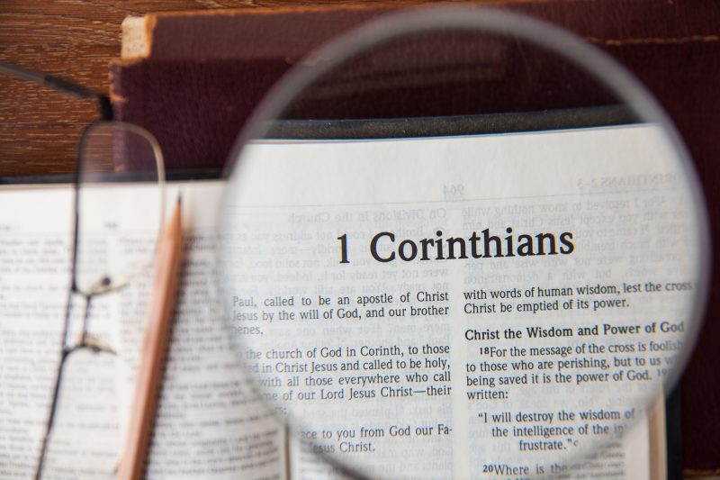 CHIANGMAI, THAILAND, March 3,2015. Reading The New International Version of the Holy Bible on the page of " 1corinthians " at home. March 3,2015
